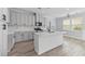 Modern kitchen with white cabinets, marble countertops, stainless steel appliances, and a central island at 215 Overcup Loop, Summerville, SC 29486