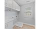 The laundry room features cabinets, a utility sink, and washer/dryer hookups at 215 Overcup Loop, Summerville, SC 29486