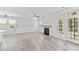 Open living room with shiplap accent wall, a fireplace, and lots of natural light at 215 Overcup Loop, Summerville, SC 29486
