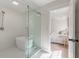Bright bathroom features a glass-enclosed shower and a peek into the primary bedroom at 2226 Red Fern Lane, Mount Pleasant, SC 29466