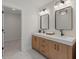 Modern bathroom features a double vanity, stylish mirrors, and marble flooring at 2226 Red Fern Lane, Mount Pleasant, SC 29466