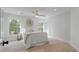Spacious bedroom with hardwood floors, two large windows, and a cozy, neutral decor at 2226 Red Fern Lane, Mount Pleasant, SC 29466