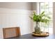 Close up on decor showing greenery, a gold tray, a woven chair and natural light at 2226 Red Fern Lane, Mount Pleasant, SC 29466