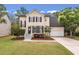Charming two-story home with manicured lawn, tidy landscaping, black shutters and a welcoming front porch at 2226 Red Fern Lane, Mount Pleasant, SC 29466