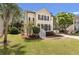 Two story home with mature trees, manicured lawn and landscaping, and a welcoming front porch at 2226 Red Fern Lane, Mount Pleasant, SC 29466
