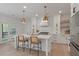 Well-lit kitchen with a large center island, modern pendant lights, and stainless steel appliances provides a stylish space at 2226 Red Fern Lane, Mount Pleasant, SC 29466
