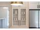 Bright kitchen featuring glass-front cabinetry, stainless steel refrigerator, and modern pendant lighting at 2226 Red Fern Lane, Mount Pleasant, SC 29466