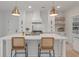 Bright kitchen features a large island, quartz countertops, stainless steel appliances, and pendant lighting at 2226 Red Fern Lane, Mount Pleasant, SC 29466