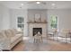 Comfortable living room features bright windows, neutral paint, a fireplace, and modern furniture for a relaxing atmosphere at 2226 Red Fern Lane, Mount Pleasant, SC 29466