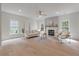 Inviting living room with fireplace, light-filled windows, comfortable seating, and a modern rug creates a relaxing space at 2226 Red Fern Lane, Mount Pleasant, SC 29466