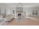 Bright living room boasts a fireplace, ceiling fan, neutral colors, and stylish furniture for a cozy and inviting atmosphere at 2226 Red Fern Lane, Mount Pleasant, SC 29466