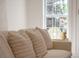 A bright living room shows a modern couch with some pillows and a decorative table with a lamp next to the window at 2226 Red Fern Lane, Mount Pleasant, SC 29466