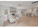 Open concept living room with a fireplace, hardwood floors, and a seamless flow to the kitchen at 2226 Red Fern Lane, Mount Pleasant, SC 29466