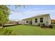 A view of the backyard featuring a well maintained lawn and covered patio at 2243 Macallan Blvd, Ravenel, SC 29470
