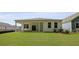A view of the backyard featuring a well maintained lawn and covered patio at 2243 Macallan Blvd, Ravenel, SC 29470