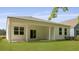 A view of the backyard featuring a well maintained lawn and covered patio at 2243 Macallan Blvd, Ravenel, SC 29470