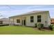A view of the backyard featuring a well maintained lawn and covered patio at 2243 Macallan Blvd, Ravenel, SC 29470