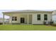 A view of the backyard featuring a well maintained lawn and covered patio at 2243 Macallan Blvd, Ravenel, SC 29470