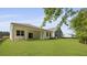A view of the backyard featuring a well maintained lawn and covered patio at 2243 Macallan Blvd, Ravenel, SC 29470