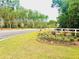 Landscaped entrance to the community with flowerbeds along the road at 2243 Macallan Blvd, Ravenel, SC 29470