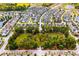 A vibrant aerial view of a neighborhood with lush greenery and community green space, homes and ponds at 2519 Rutherford Way, Charleston, SC 29414