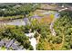 Aerial view showcasing a community pool in a scenic, wooded area near winding waterways at 2519 Rutherford Way, Charleston, SC 29414