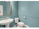 Stylish powder room with designer mirror, modern vanity, and elegant turquoise wall paneling at 2519 Rutherford Way, Charleston, SC 29414