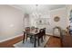 Bright dining room boasts hardwood floors, and an elegant chandelier above a modern table with seating for six at 2519 Rutherford Way, Charleston, SC 29414