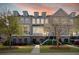Charming townhome with brick accents, landscaped front yard, and inviting entryway at sunset at 2519 Rutherford Way, Charleston, SC 29414