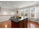 Bright kitchen featuring an island with dark granite countertops, and hardwood floors at 2519 Rutherford Way, Charleston, SC 29414