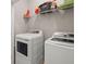 Laundry room with modern washer and dryer, complemented by overhead shelving at 2519 Rutherford Way, Charleston, SC 29414