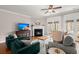 Bright living room with fireplace, hardwood floors, and access to outdoor space through French doors at 2519 Rutherford Way, Charleston, SC 29414