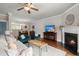Open concept living room and dining area with fireplace, hardwood floors, and stylish furniture at 2519 Rutherford Way, Charleston, SC 29414