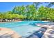 Inviting community pool with ample seating, trees, shade, and a ' playground for enjoyable outdoor recreation at 2519 Rutherford Way, Charleston, SC 29414