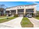 Charming tan townhomes with brick accents, garages, screened porches, driveways, and healthy, green lawns at 2519 Rutherford Way, Charleston, SC 29414