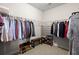 Spacious walk-in closet with wire shelving for clothes and shoe racks and bench at 2519 Rutherford Way, Charleston, SC 29414