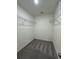 Generous walk-in closet with overhead wire shelving for optimal storage and organization at 2602 Scarlett Maple St, Summerville, SC 29486