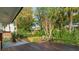 Private backyard featuring a wooden deck, brick patio, and mature landscaping at 3 Lauden Blvd, Isle of Palms, SC 29451