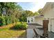 Lush backyard features a well-maintained lawn, a charming patio with a wooden deck, and mature trees at 3 Lauden Blvd, Isle of Palms, SC 29451