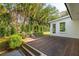 Spacious wooden deck overlooks a lush backyard with tropical landscaping at 3 Lauden Blvd, Isle of Palms, SC 29451