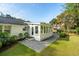 Spacious backyard with a well-manicured lawn, leading to a sunroom and patio perfect for outdoor enjoyment at 3 Lauden Blvd, Isle of Palms, SC 29451