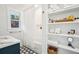 Bright bathroom offering an alcove bathtub, and open shelving for linens and toiletries storage at 3 Lauden Blvd, Isle of Palms, SC 29451