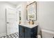 Stylish bathroom featuring a navy blue vanity, marble countertop, and hexagon tile flooring at 3 Lauden Blvd, Isle of Palms, SC 29451