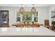 Light filled dining room features modern chandelier lighting, large picture windows and breakfast bar seating at 3 Lauden Blvd, Isle of Palms, SC 29451