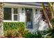 Charming home featuring a white brick facade, new front door, modern lighting, and beautiful landscaping at 3 Lauden Blvd, Isle of Palms, SC 29451