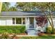 Charming home exterior with a blue front door, complemented by manicured greenery and a brick facade at 3 Lauden Blvd, Isle of Palms, SC 29451