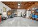 Spacious garage with exposed wood ceiling, storage shelves, and organizational features at 3 Lauden Blvd, Isle of Palms, SC 29451