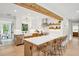 Open kitchen area showcasing a kitchen island with seating, a farmhouse sink, and stainless steel appliances at 3 Lauden Blvd, Isle of Palms, SC 29451