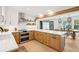 Bright kitchen boasts stainless steel appliances, light wood cabinets and breakfast bar seating overlooking the dining room at 3 Lauden Blvd, Isle of Palms, SC 29451