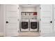 Convenient laundry room with modern washer and dryer units and ample storage shelves at 3 Lauden Blvd, Isle of Palms, SC 29451